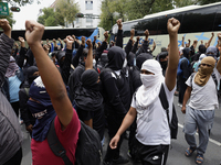 Colleagues of the 43 missing students from Ayotzinapa protest with fists raised outside the Ministry of the Interior in Mexico City, Mexico,...