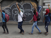 Colleagues of the 43 missing students from Ayotzinapa protest with fists raised outside the Ministry of the Interior in Mexico City, Mexico,...