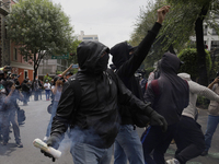 Colleagues of the 43 missing students from Ayotzinapa fire rockets on Monday, September 23, 2024, outside the Ministry of the Interior in Me...