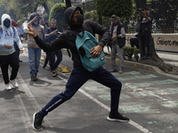 Colleagues of the 43 missing students from Ayotzinapa fire rockets on Monday, September 23, 2024, outside the Ministry of the Interior in Me...