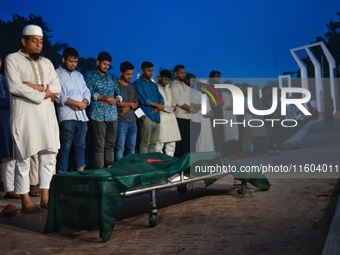 People perform the funeral prayer for Junaid Islam Ratul at the Central Shaheed Minar in Dhaka, Bangladesh, on September 23, 2024. Ratul, wh...