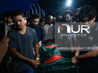 People perform the funeral prayer for Junaid Islam Ratul at the Central Shaheed Minar in Dhaka, Bangladesh, on September 23, 2024. Ratul, wh...