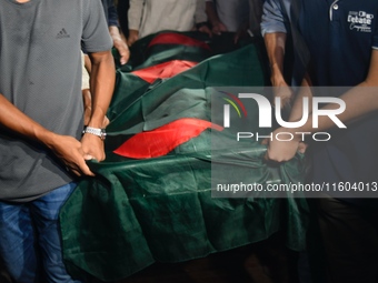 People perform the funeral prayer for Junaid Islam Ratul at the Central Shaheed Minar in Dhaka, Bangladesh, on September 23, 2024. Ratul, wh...