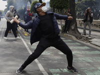 Colleagues of the 43 missing students from Ayotzinapa fire rockets on Monday, September 23, 2024, outside the Ministry of the Interior in Me...