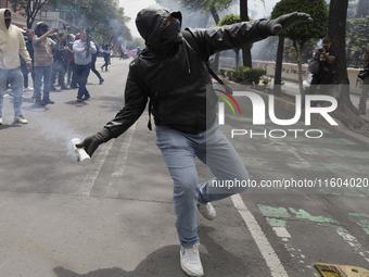 Colleagues of the 43 missing students from Ayotzinapa fire rockets on Monday, September 23, 2024, outside the Ministry of the Interior in Me...