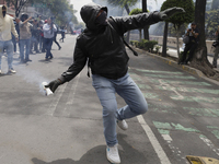 Colleagues of the 43 missing students from Ayotzinapa fire rockets on Monday, September 23, 2024, outside the Ministry of the Interior in Me...