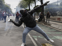 Colleagues of the 43 missing students from Ayotzinapa fire rockets on Monday, September 23, 2024, outside the Ministry of the Interior in Me...