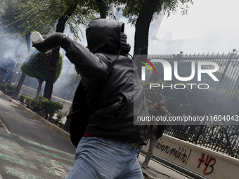 Colleagues of the 43 missing students from Ayotzinapa fire rockets on Monday, September 23, 2024, outside the Ministry of the Interior in Me...