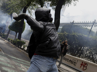 Colleagues of the 43 missing students from Ayotzinapa fire rockets on Monday, September 23, 2024, outside the Ministry of the Interior in Me...