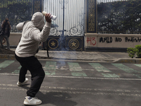 Colleagues of the 43 missing students from Ayotzinapa fire rockets on Monday, September 23, 2024, outside the Ministry of the Interior in Me...