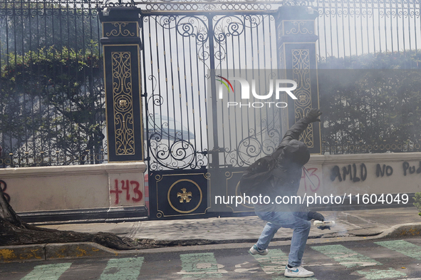 Colleagues of the 43 missing students from Ayotzinapa fire rockets on Monday, September 23, 2024, outside the Ministry of the Interior in Me...