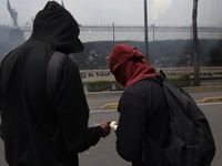 Colleagues of the 43 missing students from Ayotzinapa fire rockets on Monday, September 23, 2024, outside the Ministry of the Interior in Me...