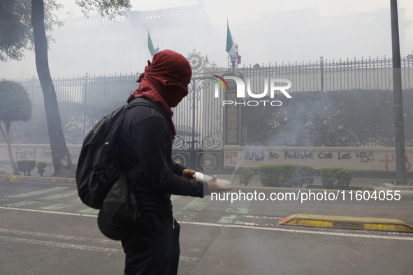 Colleagues of the 43 missing students from Ayotzinapa fire rockets on Monday, September 23, 2024, outside the Ministry of the Interior in Me...