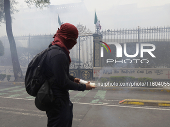 Colleagues of the 43 missing students from Ayotzinapa fire rockets on Monday, September 23, 2024, outside the Ministry of the Interior in Me...