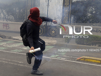 Colleagues of the 43 missing students from Ayotzinapa fire rockets on Monday, September 23, 2024, outside the Ministry of the Interior in Me...