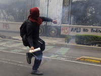 Colleagues of the 43 missing students from Ayotzinapa fire rockets on Monday, September 23, 2024, outside the Ministry of the Interior in Me...