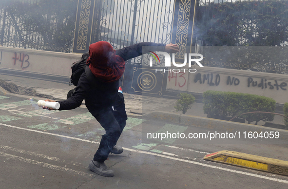 Colleagues of the 43 missing students from Ayotzinapa fire rockets on Monday, September 23, 2024, outside the Ministry of the Interior in Me...