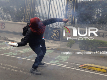 Colleagues of the 43 missing students from Ayotzinapa fire rockets on Monday, September 23, 2024, outside the Ministry of the Interior in Me...