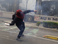 Colleagues of the 43 missing students from Ayotzinapa fire rockets on Monday, September 23, 2024, outside the Ministry of the Interior in Me...