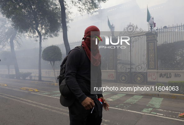 Colleagues of the 43 missing students from Ayotzinapa fire rockets on Monday, September 23, 2024, outside the Ministry of the Interior in Me...