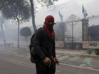 Colleagues of the 43 missing students from Ayotzinapa fire rockets on Monday, September 23, 2024, outside the Ministry of the Interior in Me...