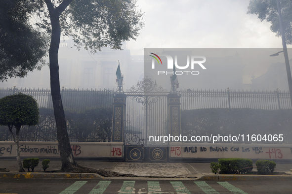 Colleagues of the 43 missing students from Ayotzinapa fire rockets on Monday, September 23, 2024, outside the Ministry of the Interior in Me...