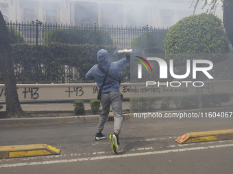 Colleagues of the 43 missing students from Ayotzinapa fire rockets on Monday, September 23, 2024, outside the Ministry of the Interior in Me...