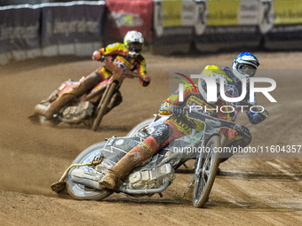 Leicester Lions' Richard Lawson in yellow leads Belle Vue Aces' guest rider Niels K. Iversen in blue and Leicester Lions' Max Fricke in whit...