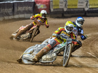 Leicester Lions' Richard Lawson in yellow leads Belle Vue Aces' guest rider Niels K. Iversen in blue and Leicester Lions' Max Fricke in whit...