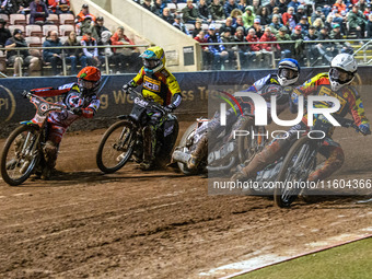 Leicester Lions' Ryan Douglas in white leads Belle Vue Aces' guest rider Niels K. Iversen in blue, Leicester Lions' guest rider Lewis Kerr i...