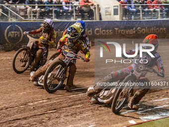 Belle Vue Aces' Jaimon Lidsey in red rides inside Leicester Lions' Sam Hagon in yellow, Belle Vue Aces' Jake Mulford in blue, and Leicester...