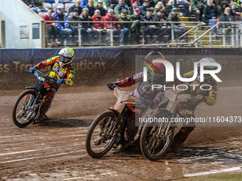 Leicester Lions' Max Fricke in white and Belle Vue Aces' Brady Kurtz in red get close with Leicester Lions' Ryan Douglas in yellow behind du...