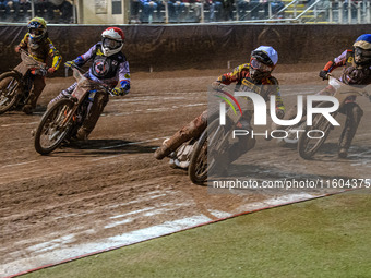 Leicester Lions' Luke Becker in white rides inside Belle Vue Aces' guest rider Niels K. Iversen in red, with Belle Vue Aces' Antti Vuolas in...