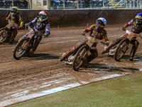 Leicester Lions' Luke Becker in white rides inside Belle Vue Aces' guest rider Niels K. Iversen in red, with Belle Vue Aces' Antti Vuolas in...