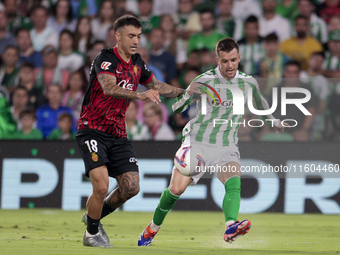 Giovani Lo Celso of Real Betis makes a center to the area during the La Liga EA Sports match between Real Betis and RCD Mallorca at Benito V...