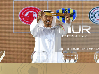 A member of the organizing committee shows the name of Duhok SC of Iraq during the 2024-25 Gulf Club Champions League draw ceremony in Doha,...