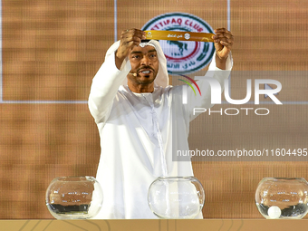 A member of the organizing committee shows the name of Al Ettifaq FC of Saudi Arabia during the 2024-25 Gulf Club Champions League draw cere...