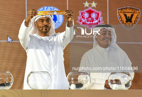 A member of the organizing committee shows the name of Al-Riffa of Bahrain during the 2024-25 Gulf Club Champions League draw ceremony in Do...