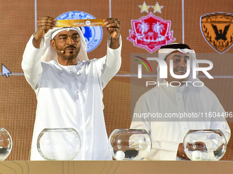 A member of the organizing committee shows the name of Al-Riffa of Bahrain during the 2024-25 Gulf Club Champions League draw ceremony in Do...