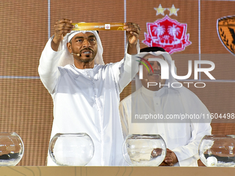 A member of the organizing committee shows the name of Dhofar of Oman during the 2024-25 Gulf Club Champions League draw ceremony in Doha, Q...