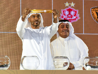 A member of the organizing committee shows the name of Dhofar of Oman during the 2024-25 Gulf Club Champions League draw ceremony in Doha, Q...