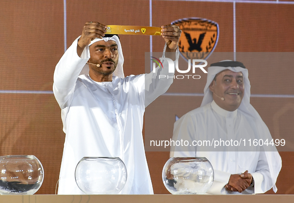 A member of the organizing committee shows the name of Al-Qadisiyah of Kuwait during the 2024-25 Gulf Club Champions League draw ceremony in...