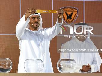 A member of the organizing committee shows the name of Al-Qadisiyah of Kuwait during the 2024-25 Gulf Club Champions League draw ceremony in...