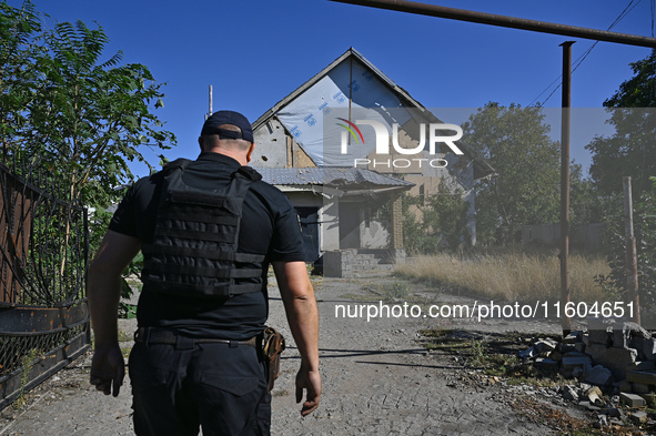 A law enforcement officer is seen on the territory of the Vozdvyzhivka territorial community in Zaporizhzhia region, southeastern Ukraine, o...