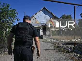 A law enforcement officer is seen on the territory of the Vozdvyzhivka territorial community in Zaporizhzhia region, southeastern Ukraine, o...