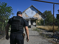 A law enforcement officer is seen on the territory of the Vozdvyzhivka territorial community in Zaporizhzhia region, southeastern Ukraine, o...