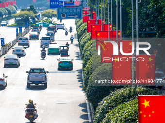 National flags fly along the Golden Buddha Avenue to celebrate the upcoming National Day in Chongqing, China, on September 24, 2024. (