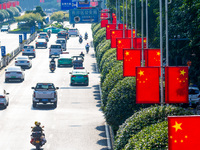 National flags fly along the Golden Buddha Avenue to celebrate the upcoming National Day in Chongqing, China, on September 24, 2024. (