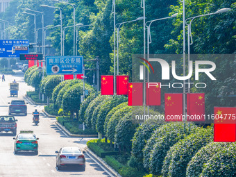 National flags fly along the Golden Buddha Avenue to celebrate the upcoming National Day in Chongqing, China, on September 24, 2024. (