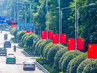 National flags fly along the Golden Buddha Avenue to celebrate the upcoming National Day in Chongqing, China, on September 24, 2024. (